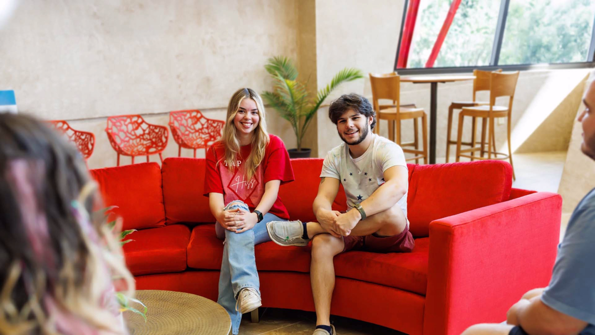 Students sitting on admissions lobby couch