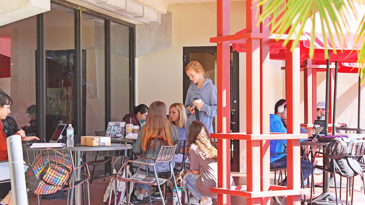 Students enjoying outdoor seating at Tutu's Cyber Cafe