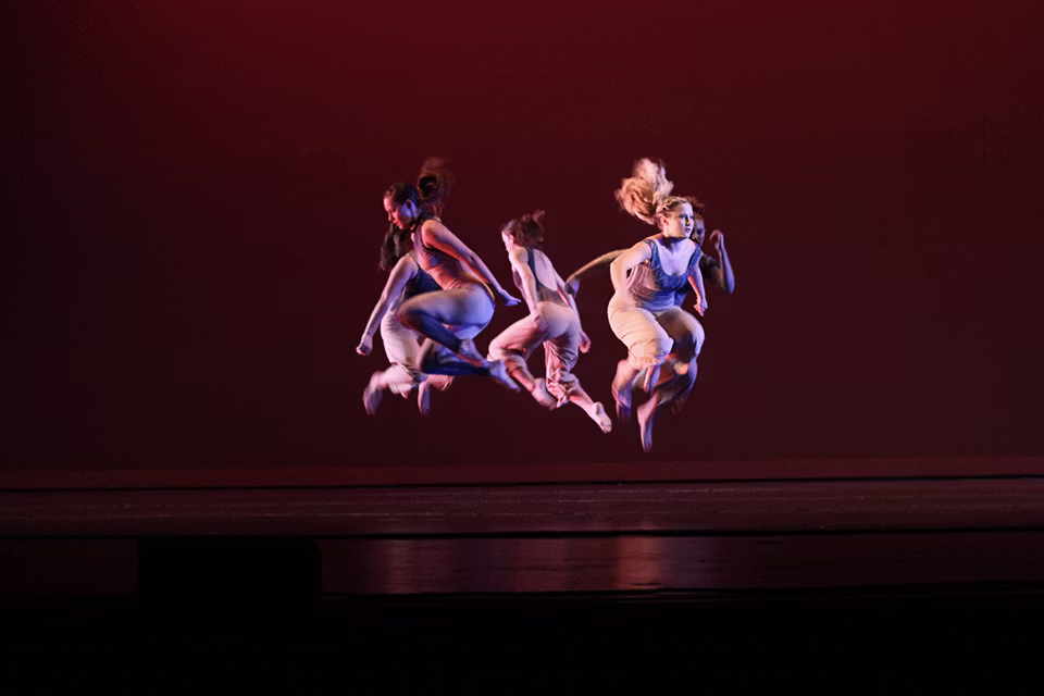 Dance students in performing a modern dance.