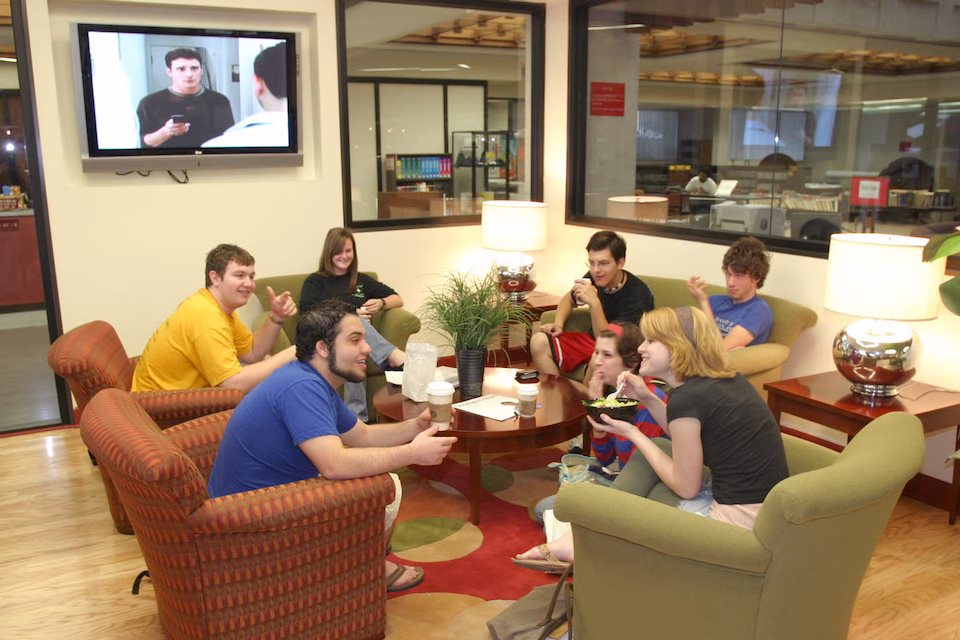 students sitting around table with food and coffee
