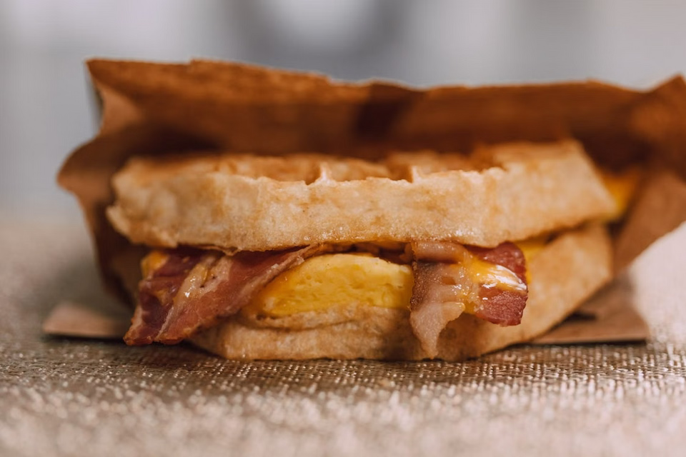 Breakfast sandwich in paper bag