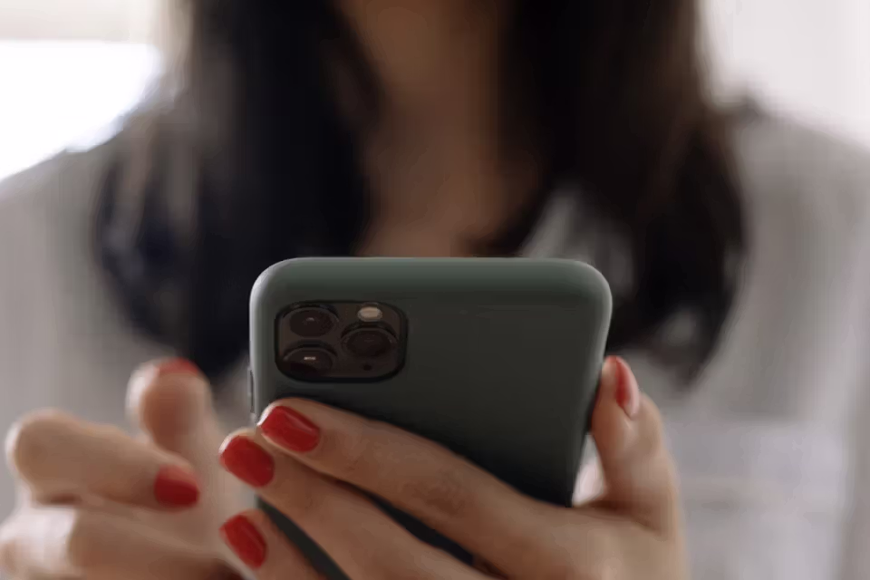 Woman typing on a cell phone