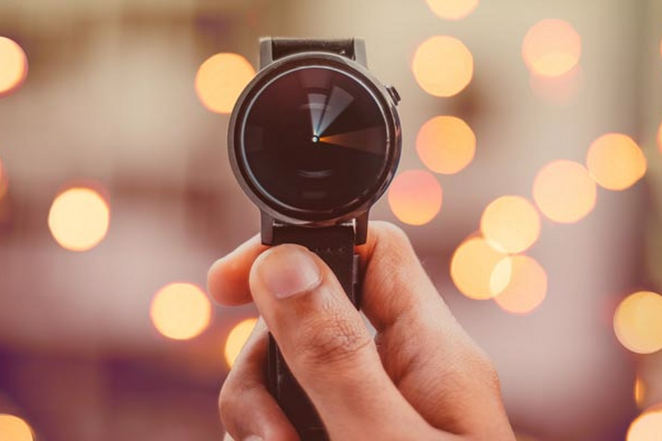Hand holding wrist watch
