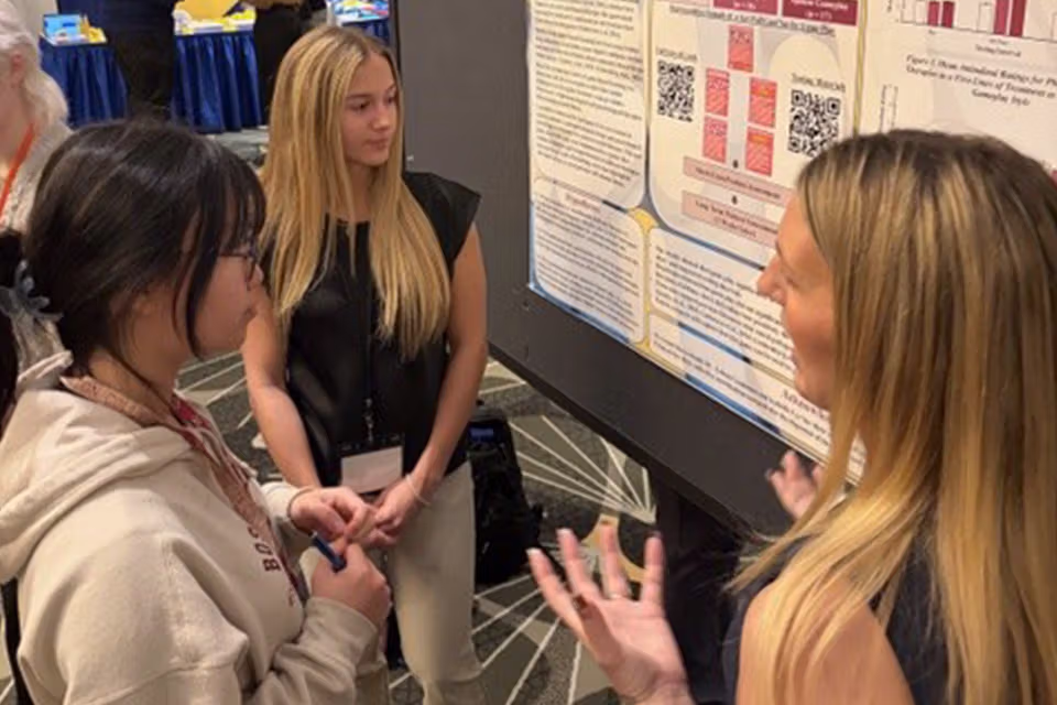 graduate students discussing poster presentations
