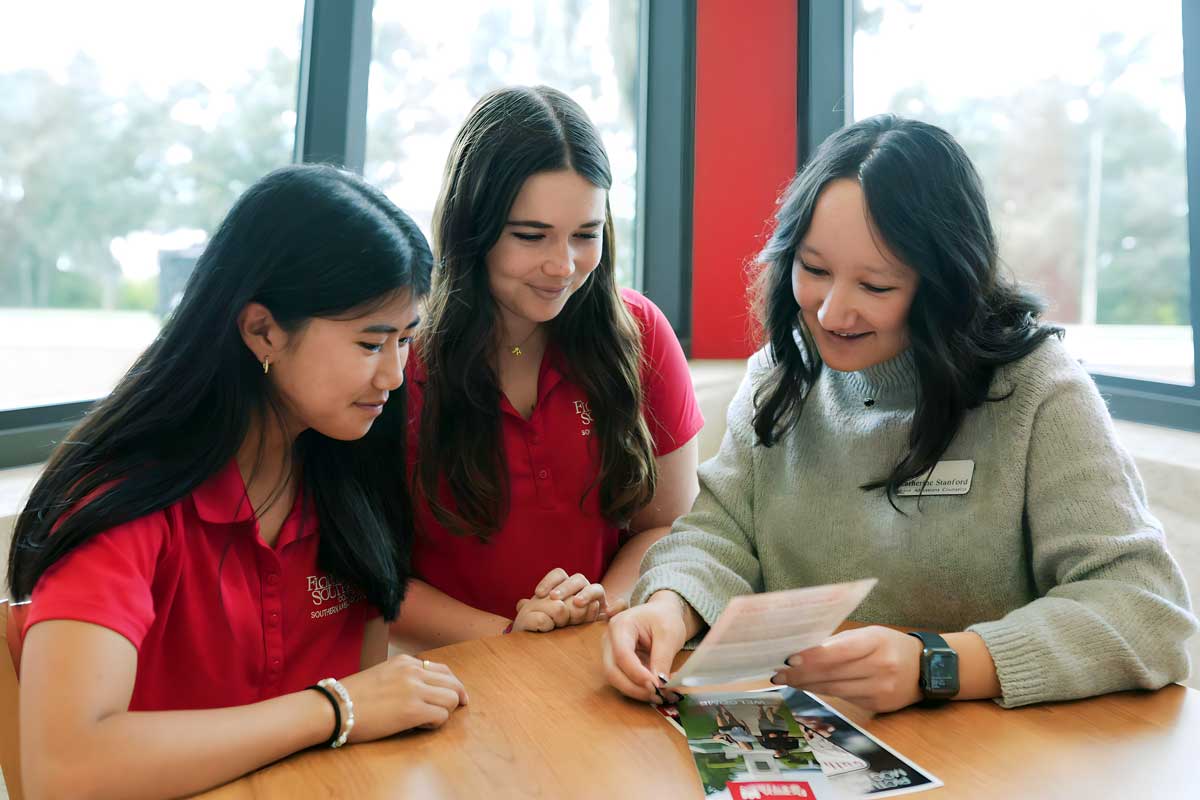 katherine showing two students info on a card