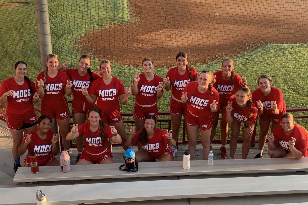 1200-800-stairs-softball.jpg The softball team posing at the bottom of a set of bleachers