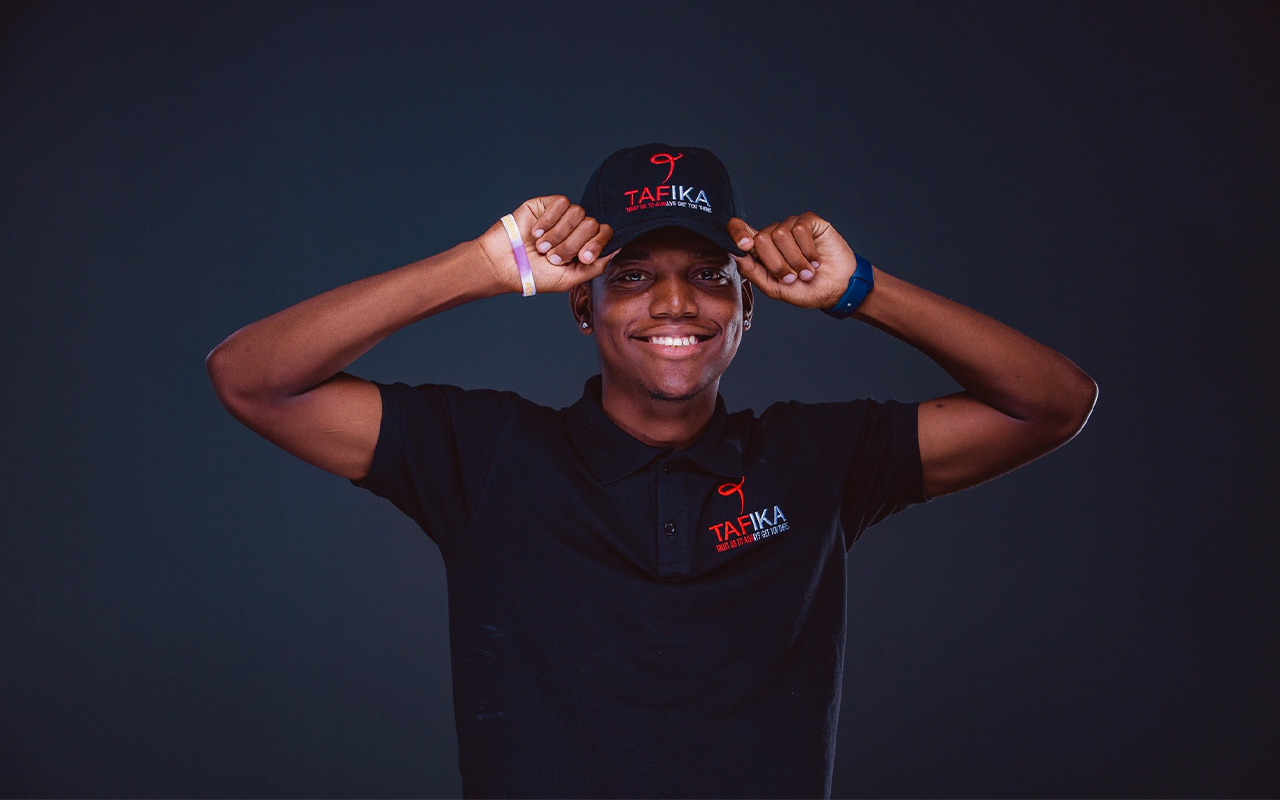 Happyson Kaunda wearing hat bearing TAFIKA logo