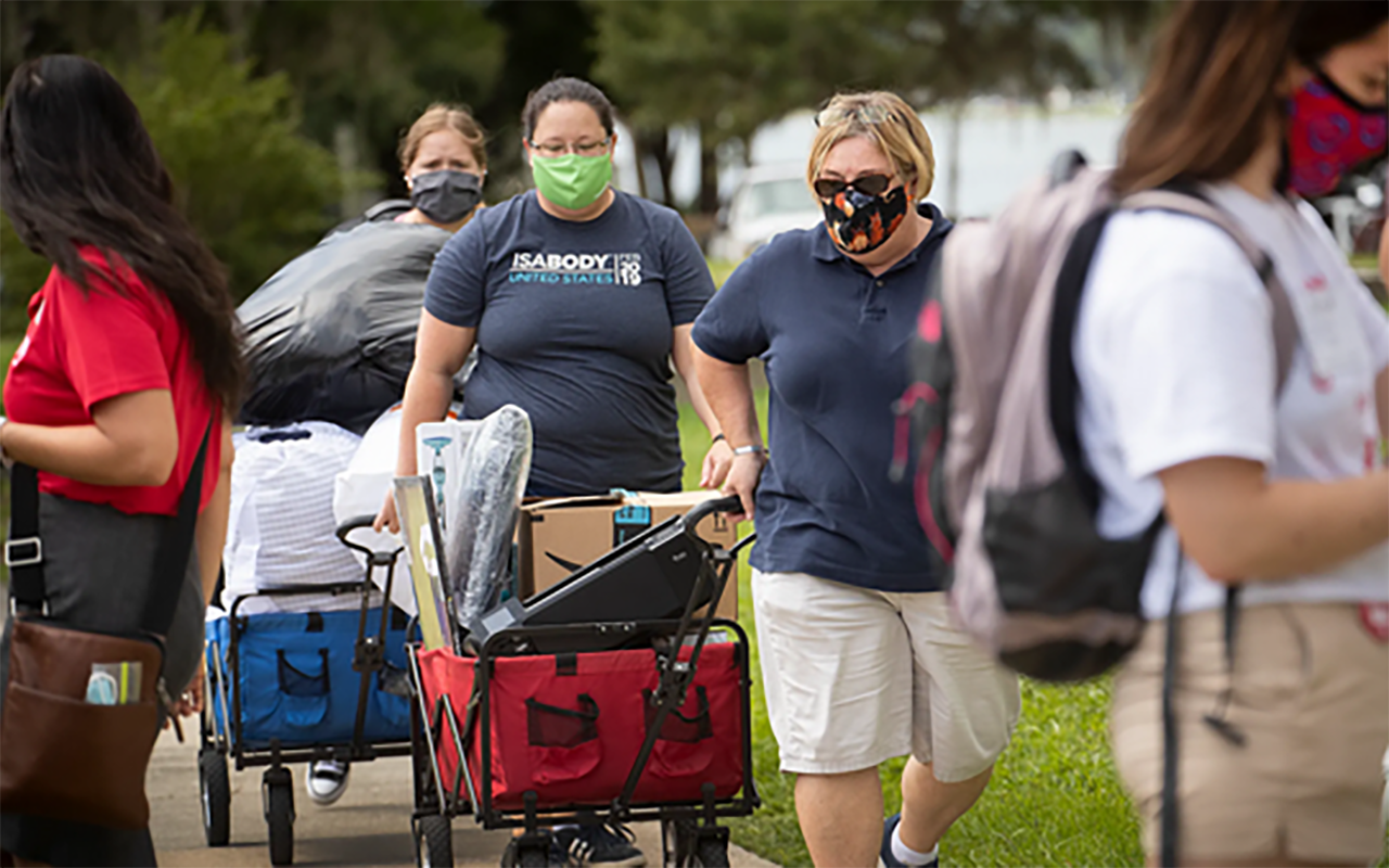 Barabara Miraglia, right, and Cassandra Currier, center, help transport their daughter 