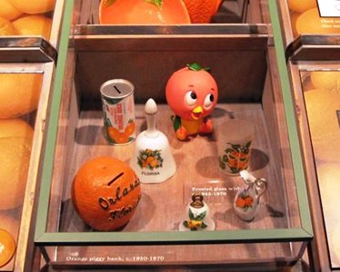 The Orange Bird display in Orlando, featuring coin banks, bells, a pitcher and a glass.
